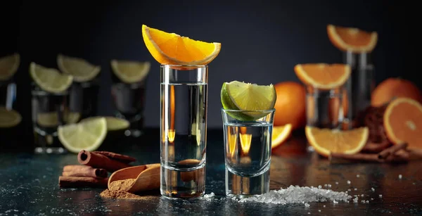 Various ways of using tequila. Tequila with lime and salt and tequila with orange and cinnamon.