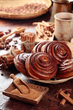 Freshly baked cinnamon buns on a kitchen table. 