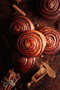 Freshly baked cinnamon buns on a kitchen table. Top view.
