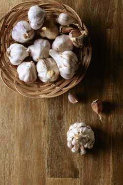 Garlic bulbs on an old wooden table. Top view.