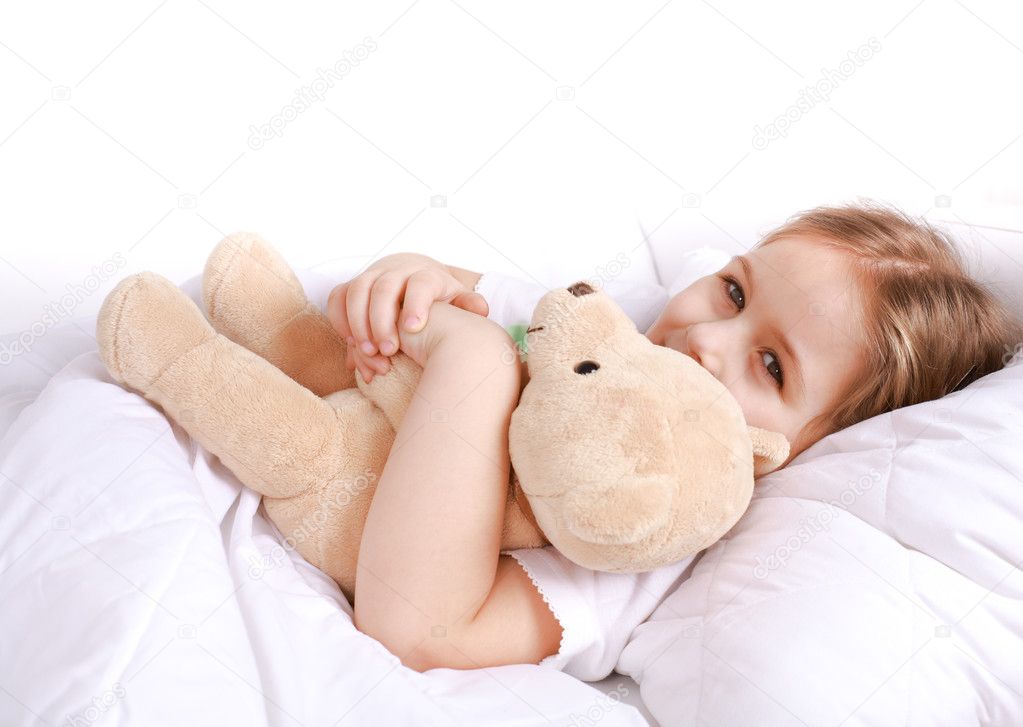 Cute girl cuddling with teddy bear