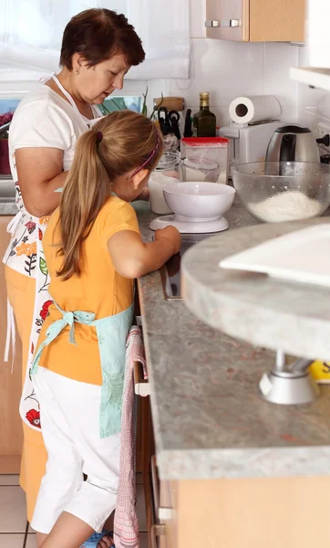 Senior woman and child baking — Stock Photo, Image