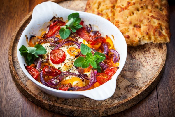 Baked feta cheese on vegetables — Stock Photo, Image