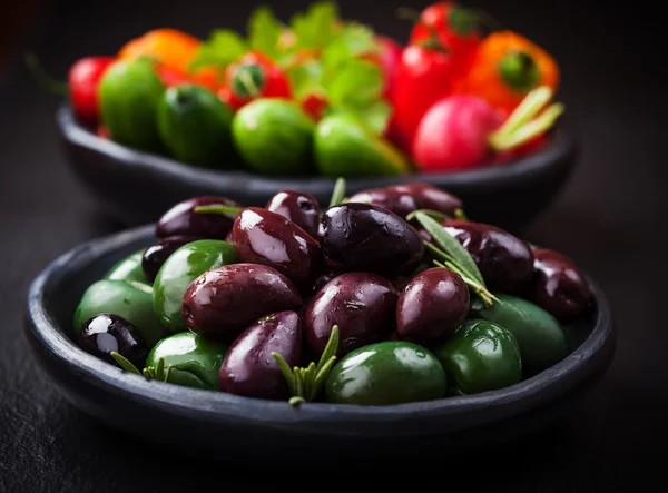 Variation of olives with raw snack vegetable — Stock Photo, Image