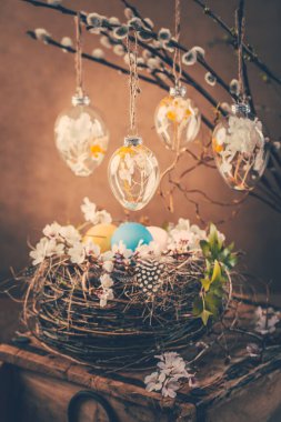 Holidays and Easter concept - nest and pussy willow branches decorated with Easter eggs  in vintage style