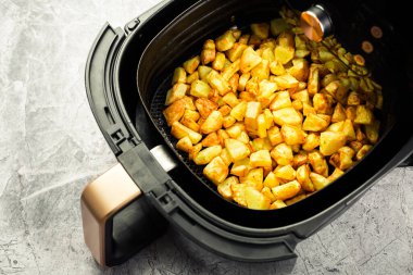 Homemade baked potatoes made in air fryer, healthy way to cook deep-fried food