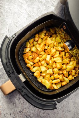 Homemade baked potatoes made in air fryer, healthy way to cook deep-fried food