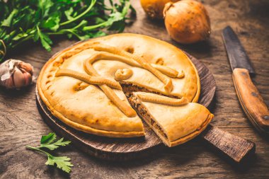 Spanish empanada - traditional meat pie with onions, Spanish cuisine