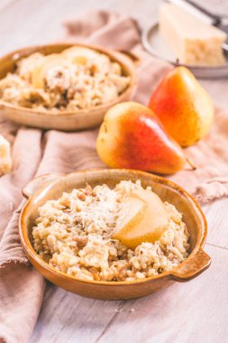 Homemade mushroom risotto with pears and  Parmesan cheese