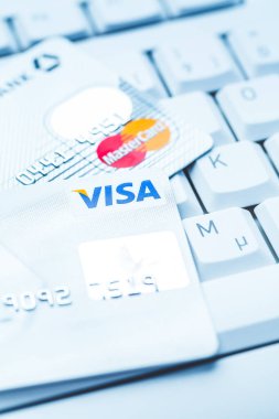 Hockenheim, Germany - September 05, 2022: Group of credit cards on computer keyboard with VISA and MasterCard brand logos