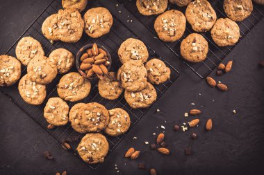 Homemade healthy almond cookies with chocolate chips on black background