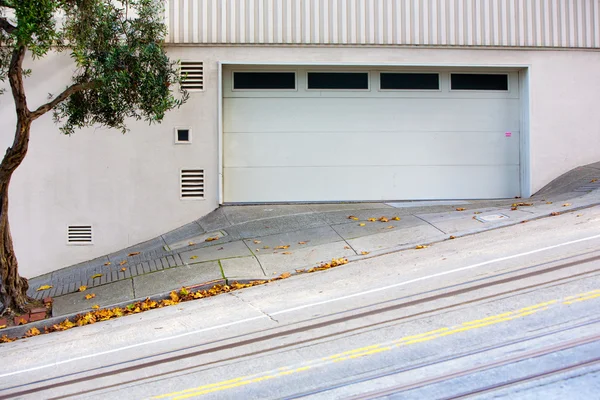 Tilted street with garage and tree — Stock Photo, Image