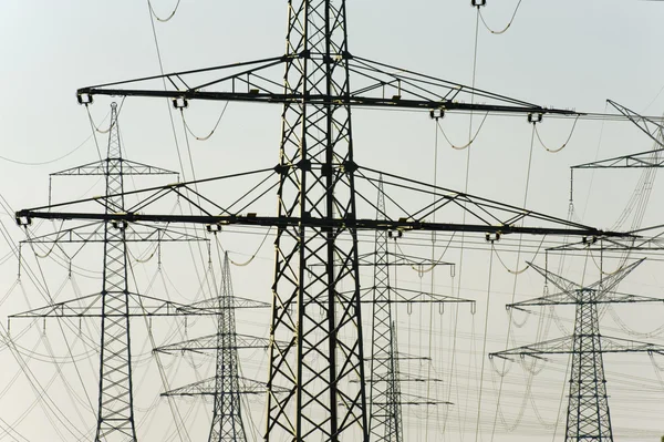 Panorama view to many electric power poles — Stock Photo, Image