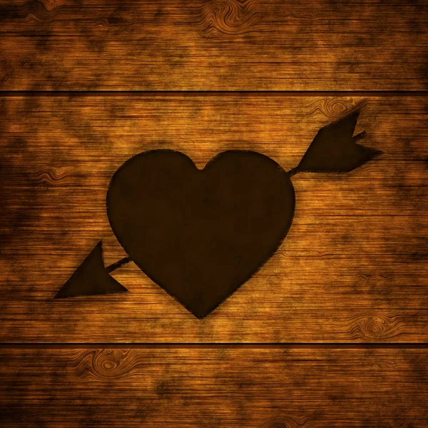 Wooden background with burnt heart — Stock Photo, Image