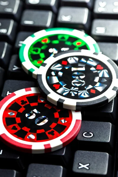 Poker chips on computer keyboard — Stock Photo, Image