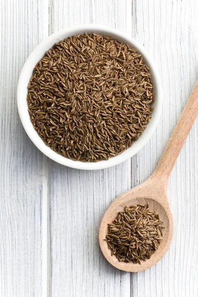 Cumin seeds in wooden spoon — Stock Photo, Image