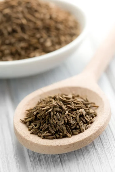 Cumin seeds in wooden spoon — Stock Photo, Image