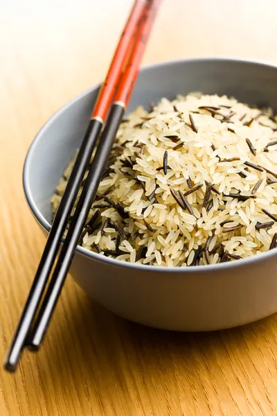 Wild rice in ceramic bowl and chopsticks — Stock Photo, Image