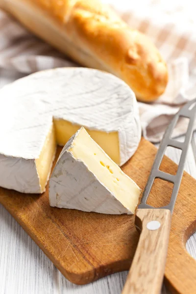 Camembert cheese on kitchen table — Stock Photo, Image