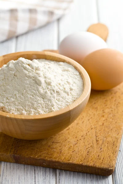 Flour and eggs on kitchen table — Stock Photo, Image