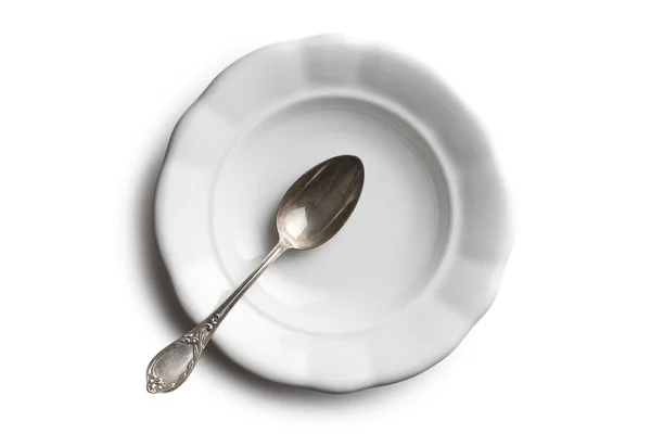 Antique ceramic plate and silver spoon — Stock Photo, Image