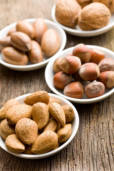 Various nuts in ceramic bowls — Stock Photo, Image