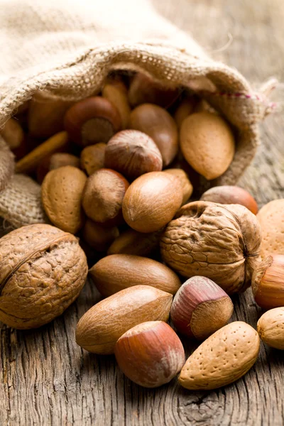 Various nuts in jute sack — Stock Photo, Image