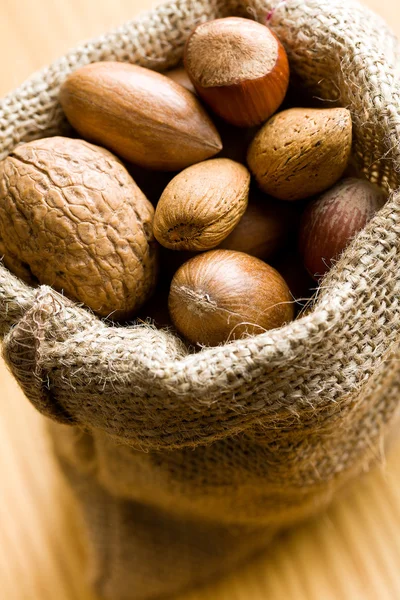 Various nuts in jute bag — Stock Photo, Image