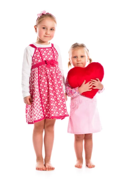 Two sisters with heart Royalty Free Stock Photos