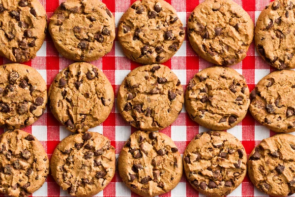 Chocolate cookies on checkered tablecloth — Stock Photo, Image