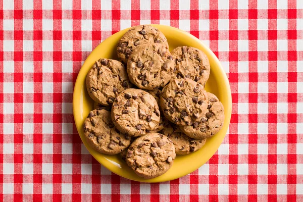 Chocolate cookies on checkered tablecloth — Stock Photo, Image