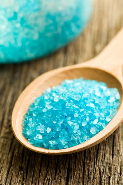 Blue bath salt in wooden spoon — Stock Photo, Image