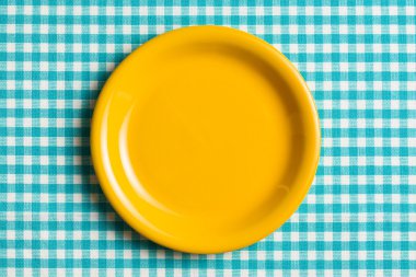 empty plate on checkered tablecloth clipart