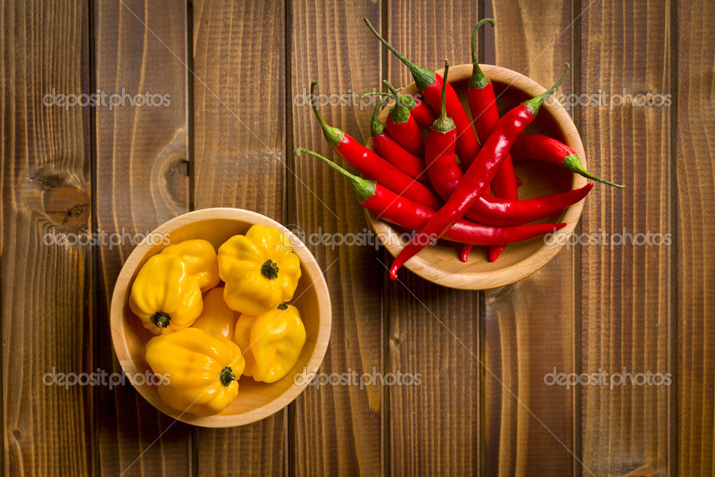Red chili peppers and habanero on wooden table Stock Photo by ©jirkaejc  32456289