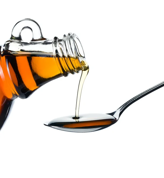 Maple syrup pouring on spoon — Stock Photo, Image