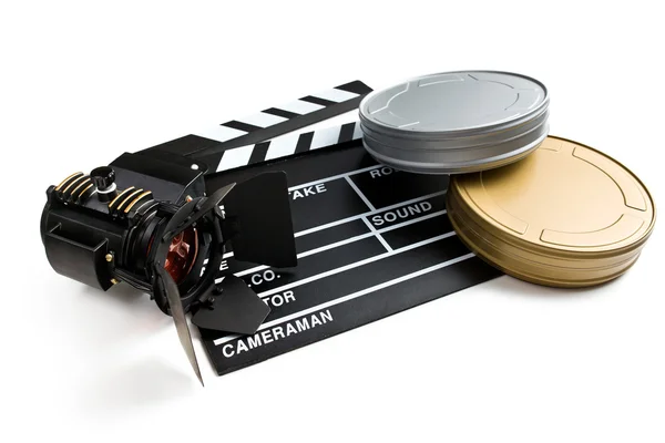 Clapper board with movie light and film reels — Stock Photo, Image