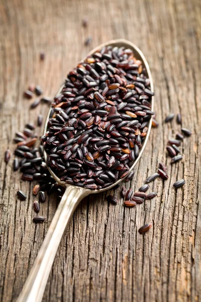 Black rice on spoon — Stock Photo, Image