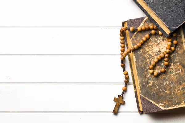 Wooden rosary beads with old book — Stock Photo, Image