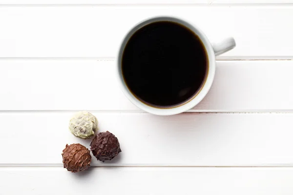 Black coffee with chocolate truffles — Stock Photo, Image