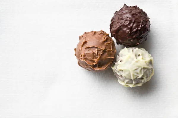 Chocolate truffles on white tablecloth — Stock Photo, Image