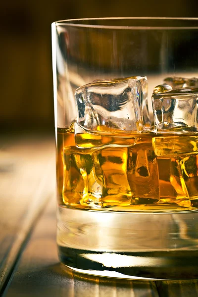 Whiskey in glass with ice — Stock Photo, Image