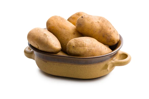 Uncooked potatoes in ceramic pot — Stock Photo, Image