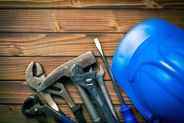 Hard hat with various working tools — Stock Photo, Image