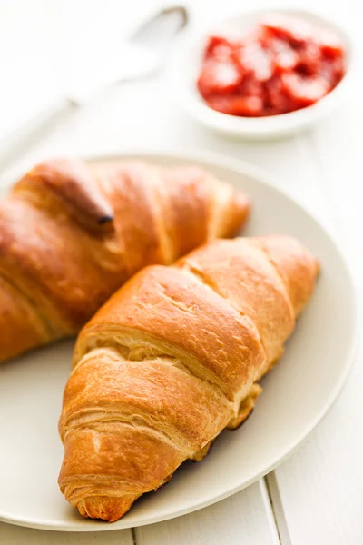 Two croissants on wooden table — Stock Photo, Image