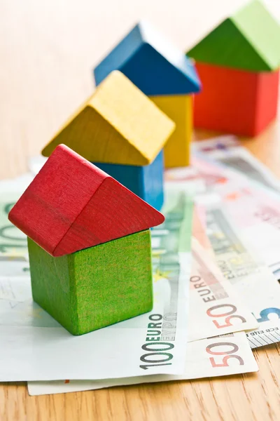 House made from wooden toy blocks with euro money — Stock Photo, Image