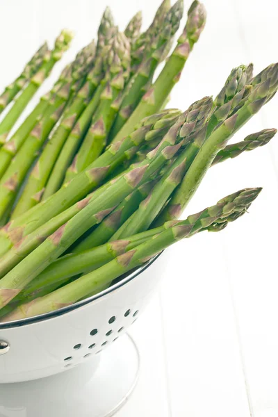 Green asparagus in colander — Stock Photo, Image