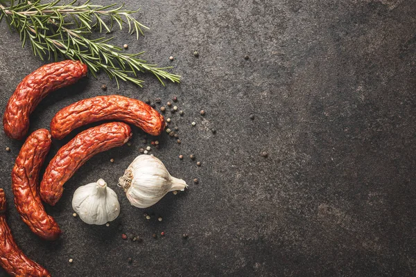Smoked Sausages Pepper Rosemary Garlic Black Table Top View — Stock fotografie