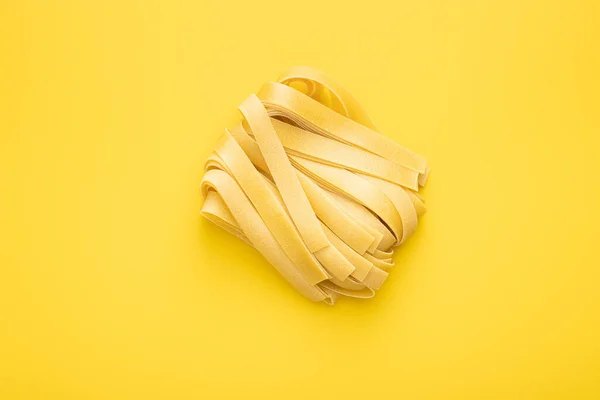 Uncooked Pappardelle Pasta Yellow Background Top View 로열티 프리 스톡 이미지