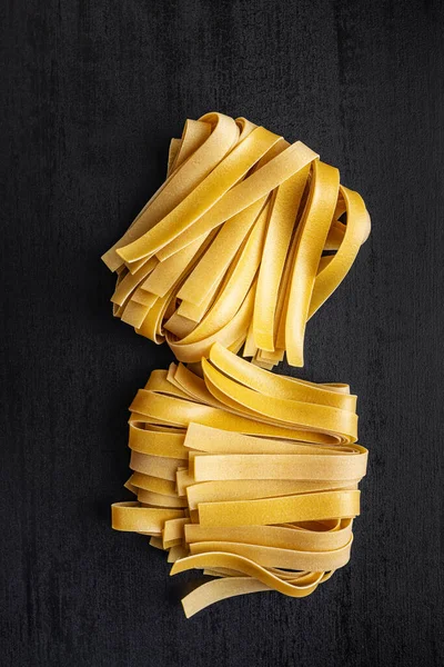 Uncooked Pappardelle Pasta Black Table Top View Stockbild