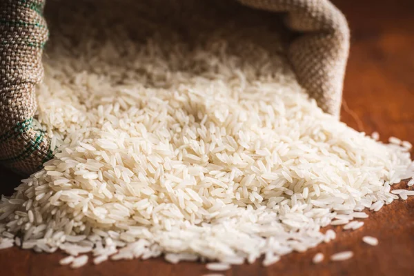 Uncooked White Rice Burlap Sack Wooden Table — Stock fotografie
